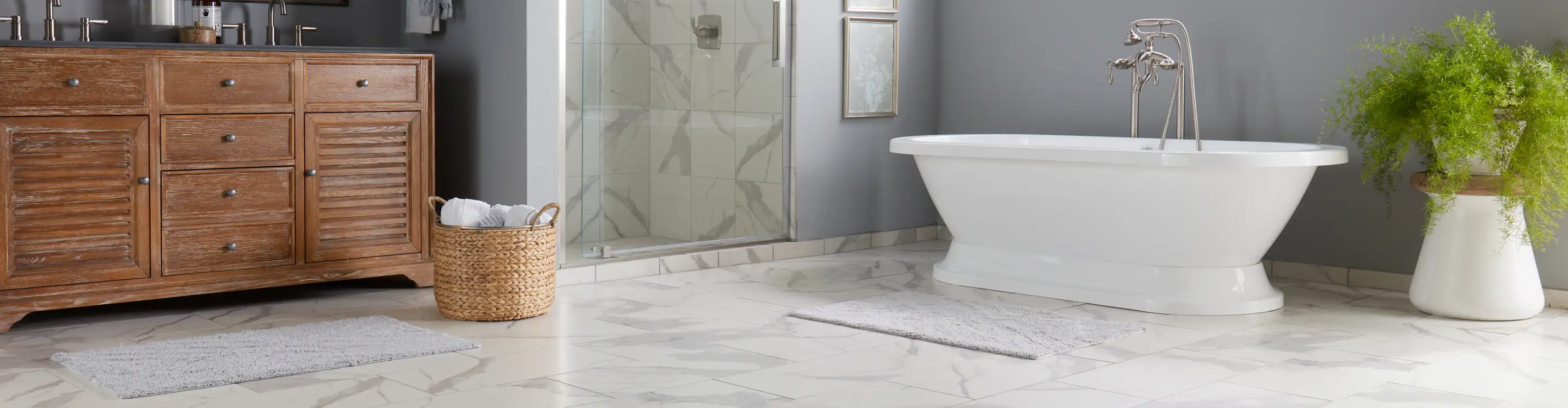 Modern bathroom with light marble-look waterproof flooring, a rustic wooden vanity, and a freestanding bathtub.